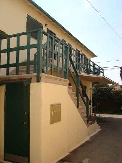 Apartment is upstairs at back. Limited parking area below and patio around corner to the left.