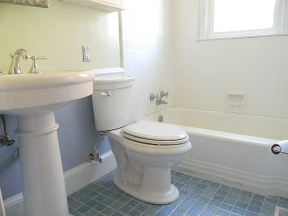 The Bathroom has tile flooring and new pedestal sink and fixtures