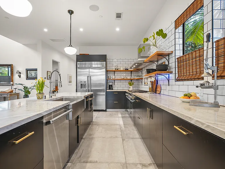 Kitchen features top of the line appliances including a six-burner stove with dual ovens