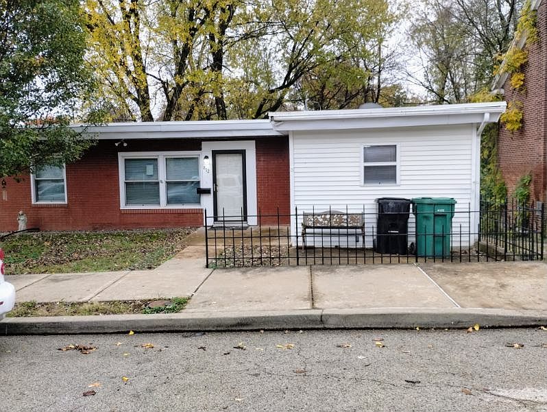 FRONT OF HOUSE HAS SITTING AREA & SMALL PATIO AREA.
