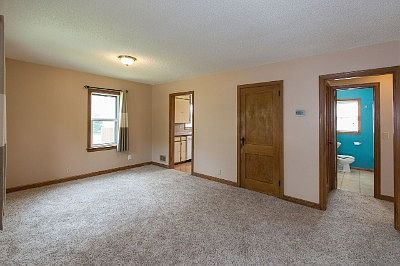 Living room with new carpet and newer windows.