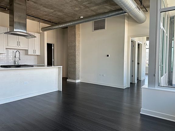 Chef's kitchen and stainless steel appliances, sun drenched in natural light
