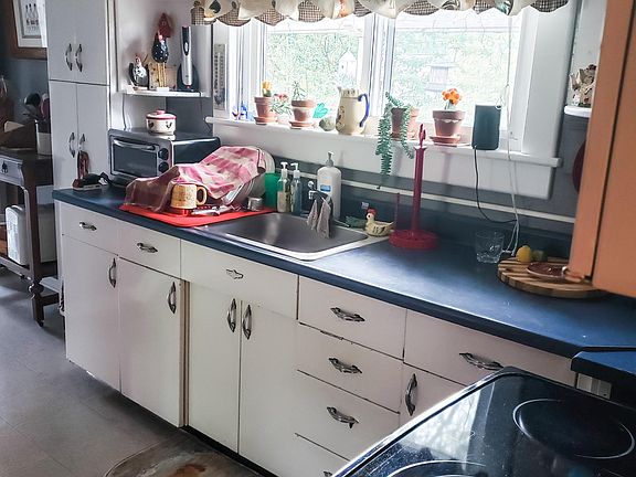 Kitchen includeS: stove and refrigerator.