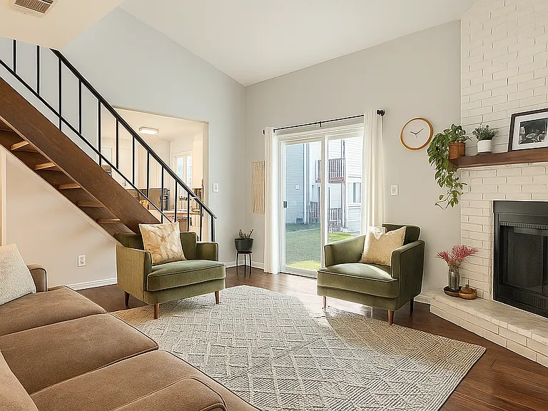 Relax in this cozy, open-concept space with vaulted ceilings, a modern fireplace, and direct access to a private patio.