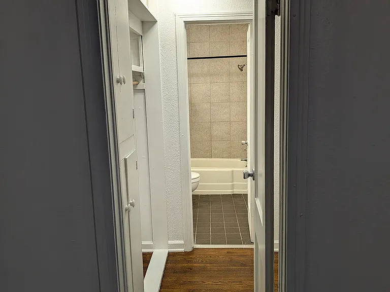 Bedroom through hallway to bathroom