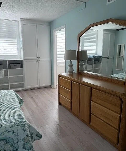 Primary has a beautiful dresser and mirror.