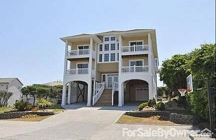 Beautiful curb appeal : Two enclosed garages with additional area for two more under car port.