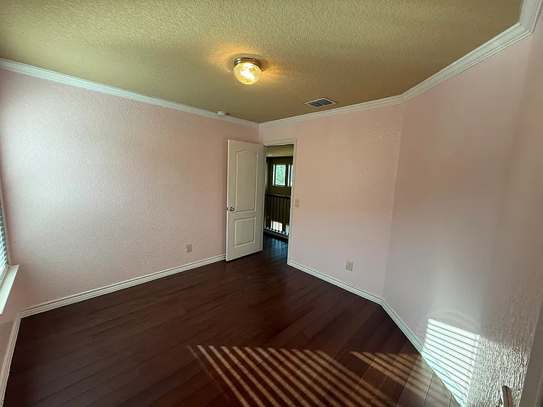 Second view from 3rd bedroom these are good sized rooms with amazing real wood custom floors