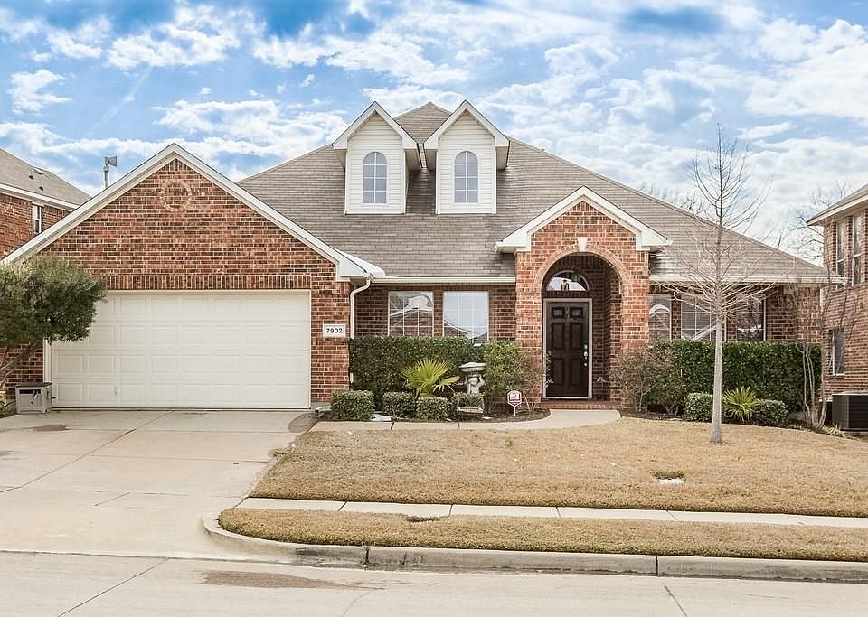 Beautiful Bricked Home with Covered Porch. Ample Space for seating that overlooks landscaped front yard.