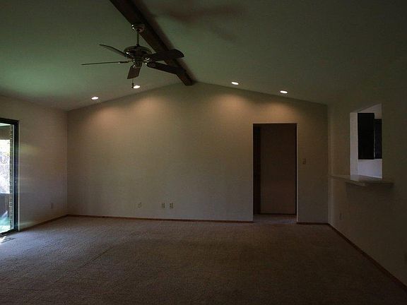 LIVING ROOM with ceiling fan, open to Kitchen on right, Larg