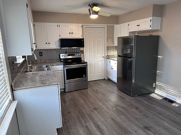 The kitchen has open area under window and against wall near LR
