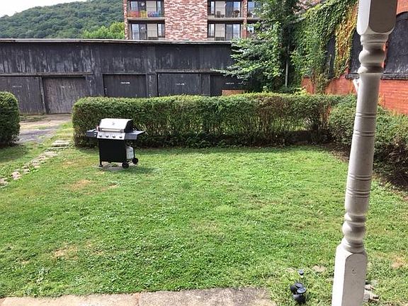 Back yard and porch are common areas shared with 1st Floor tenants. Off-street parking is on other side of hedge.
