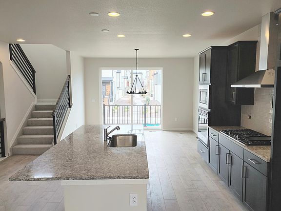 Kitchen, custom stair railing and outside deck access.