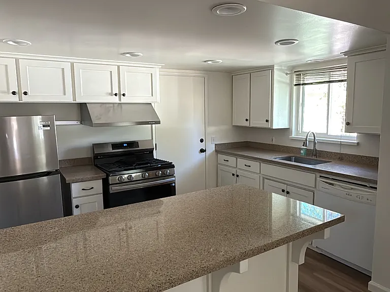 Kitchen with new refrigerator and stove