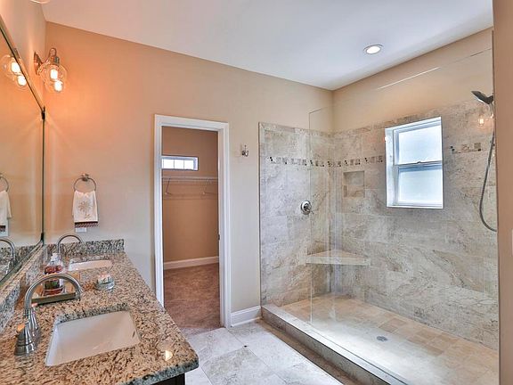 Master bathroom with walk-in shower and walk-in closet