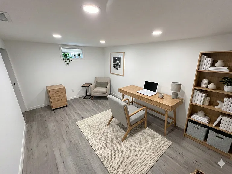 Spacious lower level bonus room set up as an office