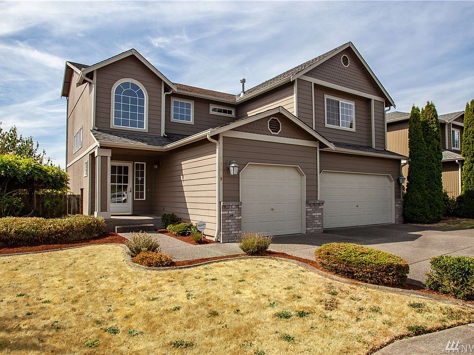 The home is situated in an established neighborhood in Lea Hill.  The home has a 3-car garage, and the garden space on the lawn is defined by custom concrete curbing.  Driveway and walkway is aggregate.