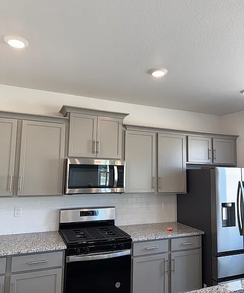 Gas cooking range, microwave, refrigerator (all brand new) wit plenty of storage with cabinets on the all as well as in the island