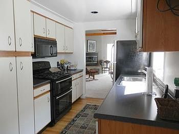 Shining wood floor in kitchen...fully applianced