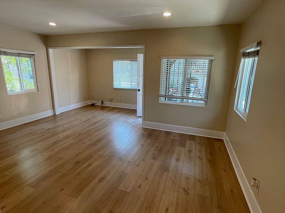 View to living room and front entrance of unit from the kitchen entrance