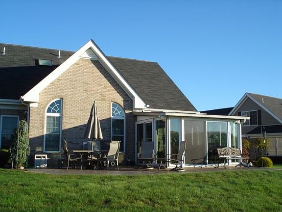 Rear including sunroom and patio