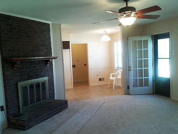 17x15 Large Family Room with wood burning fire place that leads into the kitch