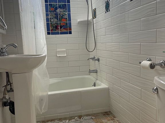 Nicely re-tiled bathroom with Catalina themed tiles