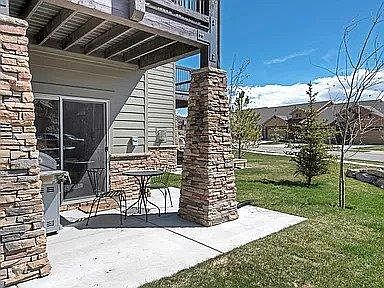 Private back patio for sitting, includes grill.