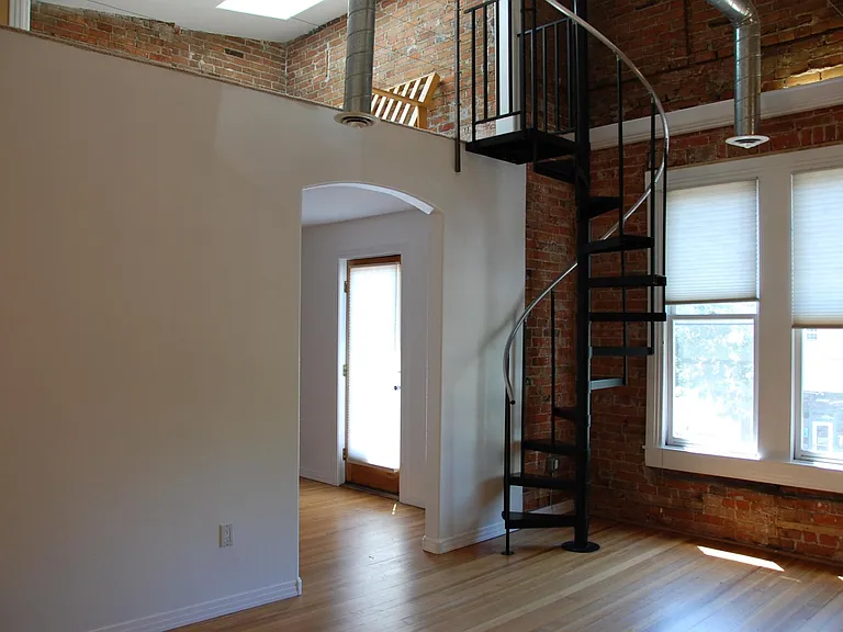 To the left is the office area with a door leading to front balcony. You can also view upstairs small loft area for extra sleeping space or watching TV. Note skylight above loft area. Spiral staircase is the access to loft area.
