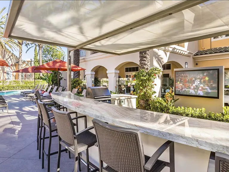 On-property outdoor lounge with wifi, built-in grill station, poolside chairs, and a TV for entertaining. Wifi.