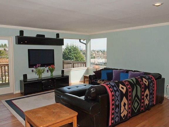 The reinvented upper level is a huge open floor plan with hardwood floors. The view deck spans the entire great room and has a gas bib for a BBQ. The open kitchen is opposite the view windows.