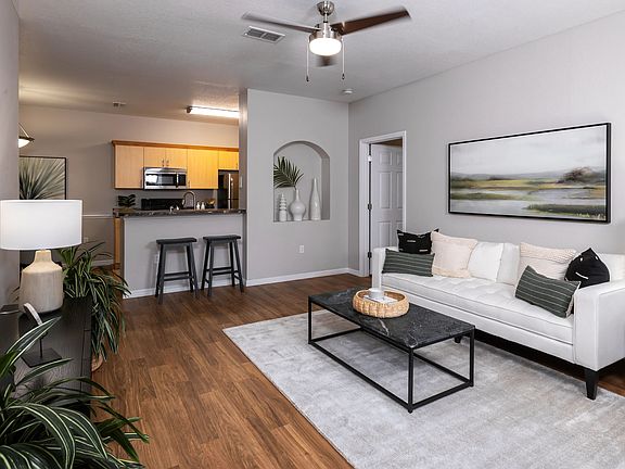 This beautifully designed living room offers an open flow to the modern kitchen, perfect for entertaining and relaxation.