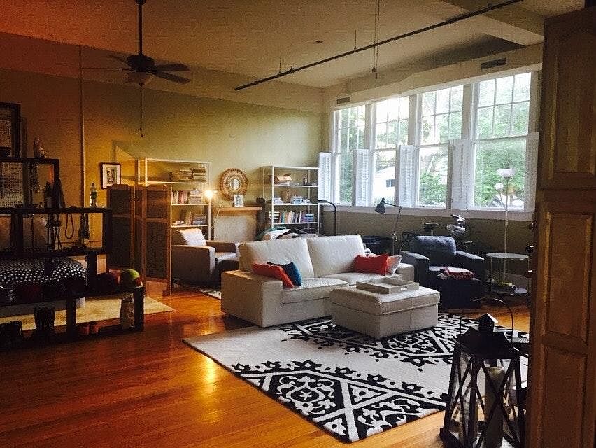main living area with large windows (partially furnished)