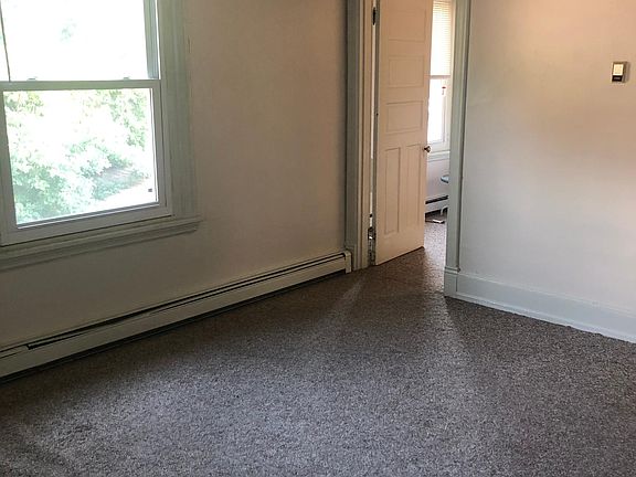 Large living room with closet, high ceilings, and great natural light.