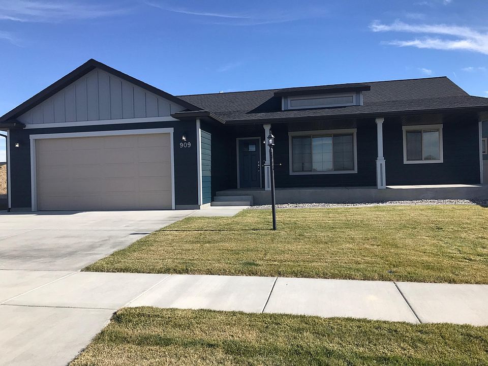 Front of Home. Nice Covered Concrete Patio. Two Car Garage.