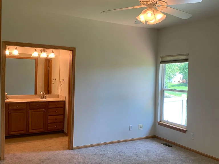 master bedroom with private bathroom and walk in closet
