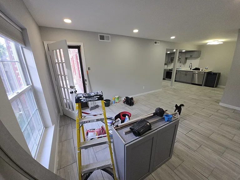 From the exterior wall in the corner looking into living room. Don't mind the mess, it will be gone by the time to move in
