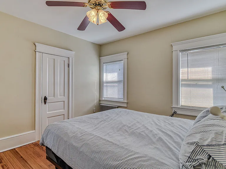 East-facing middle bedroom has queen size bed, 2 bedside tables, large dresser, ceiling fan, closet, 40" smart TV