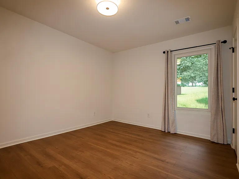 2nd Bedroom with modern lighting and beautiful floors!