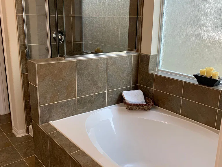 Bathroom attached to master BR with shower and full sized tub