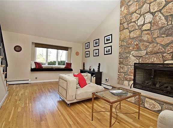 Magnificent living room with cathedral ceilings, ceiling to floor stone fireplace (wood burning).