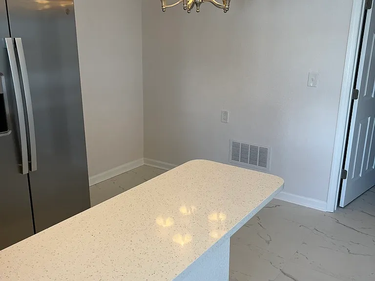 Freshly painted with bar area for extra seating.