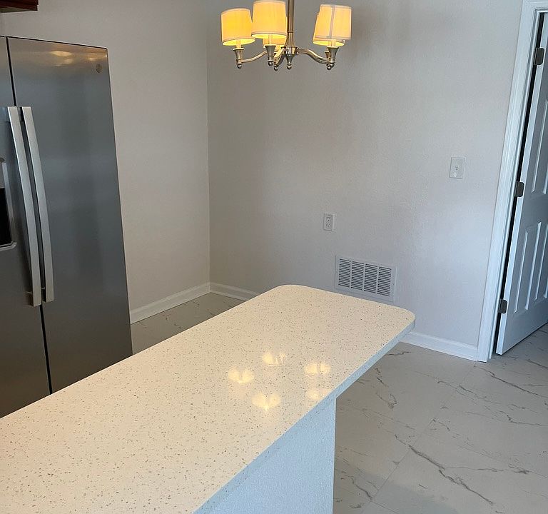 Freshly painted with bar area for extra seating.