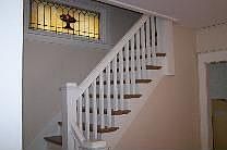 staircase with original 1920's stained glass
