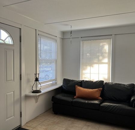 Two Units share the enclosed front vestibule with walls of windows!