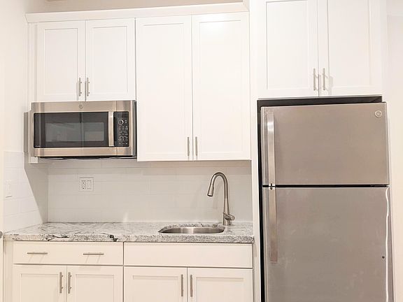 Sleek, modern kitchenette designed for efficiency. Includes a high-end multi-function microwave/convection oven and premium Refrigerator with an ice maker, perfect for preparing simple, delicious meals in your own private living space.