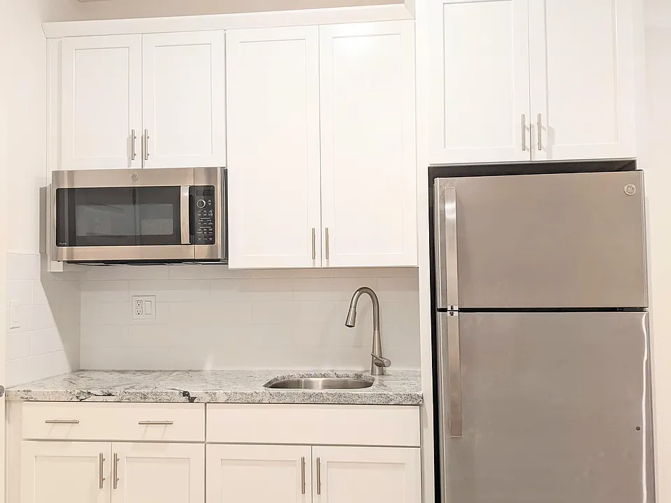 Sleek, modern kitchenette designed for efficiency. Includes a high-end multi-function microwave/convection oven and premium Refrigerator with an ice maker, perfect for preparing simple, delicious meals in your own private living space.