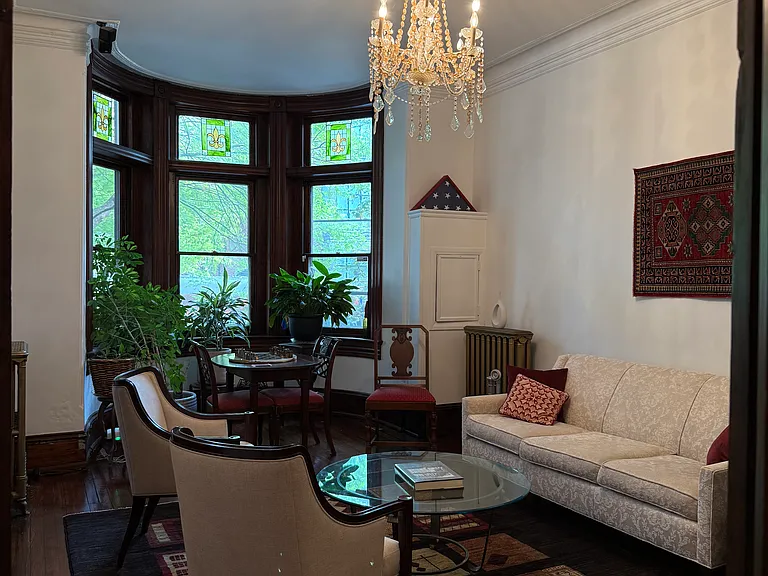 High-ceilinged living room with bow windows