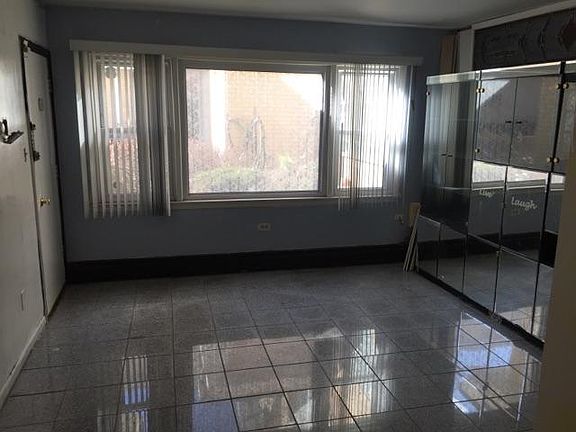 Bright living room with granite flooring.