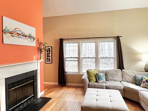 Large, sunny family room with cathedral ceilings and working fireplace
